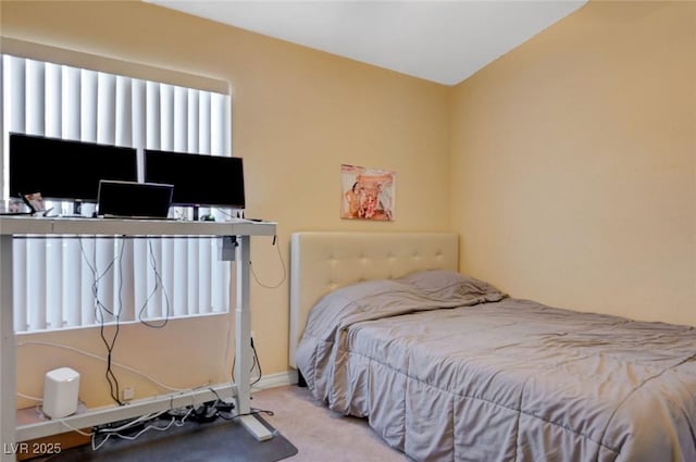 bedroom with carpet flooring and baseboards
