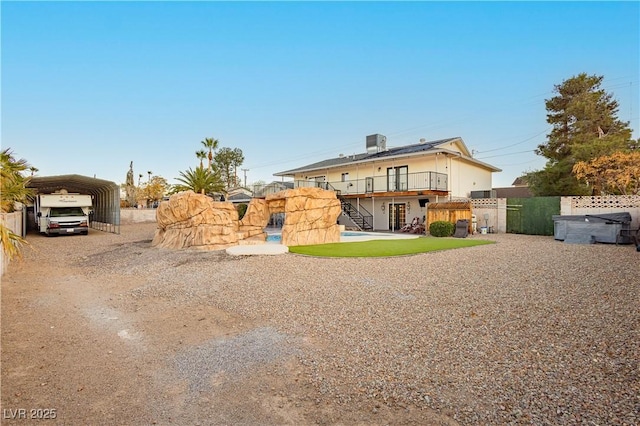 200 E Desert Rose Dr, Henderson, NV 89015 - back of property with stairs, a detached carport, fence, and dirt driveway