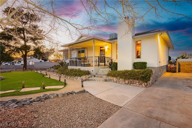 200 E Desert Rose Dr, Henderson, NV 89015 - view of front of property with covered porch, a chimney, a gate, and stucco siding