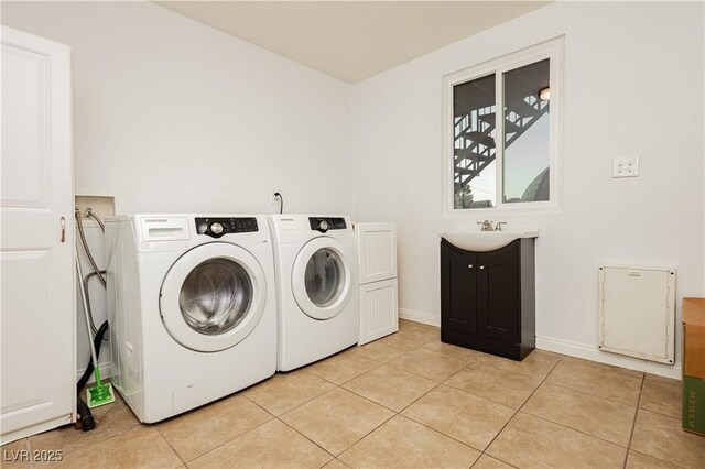 200 E Desert Rose Dr, Henderson, NV 89015 - laundry room with cabinet space, separate washer and dryer, light tile patterned floors, and baseboards