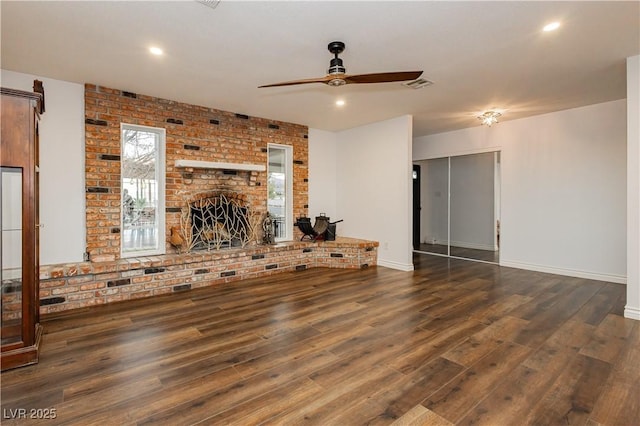 200 E Desert Rose Dr, Henderson, NV 89015 - unfurnished living room featuring a ceiling fan, wood finished floors, a brick fireplace, baseboards, and brick wall