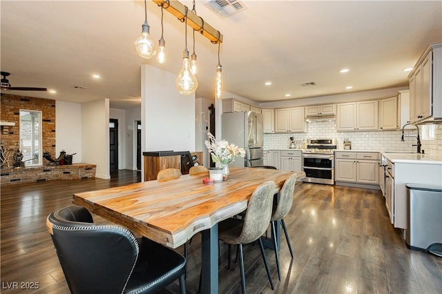 200 E Desert Rose Dr, Henderson, NV 89015 - dining room with dark wood-style floors, a ceiling fan, recessed lighting, and brick wall
