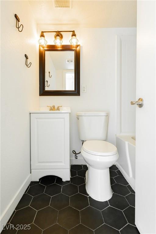 200 E Desert Rose Dr, Henderson, NV 89015 - full bathroom featuring toilet, vanity, a bath, baseboards, and tile patterned flooring