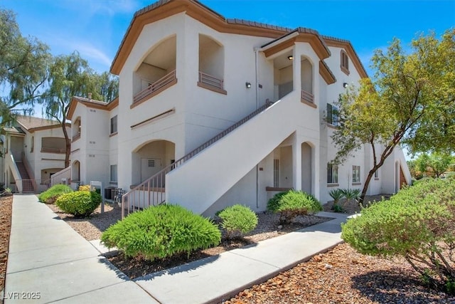 5655 E Sahara Ave Unit 2009, Las Vegas, NV 89142 - view of front of home with stucco siding, a tiled roof, and central AC