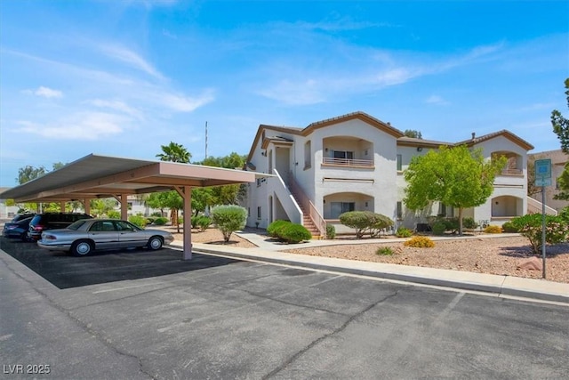 5655 E Sahara Ave Unit 2009, Las Vegas, NV 89142 - view of property featuring covered parking and stairway