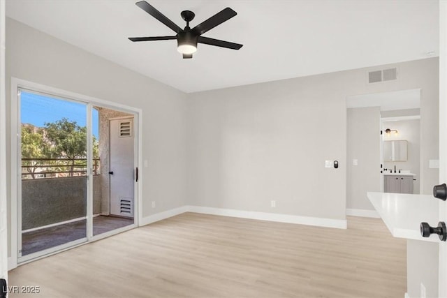 5655 E Sahara Ave Unit 2009, Las Vegas, NV 89142 - unfurnished room featuring light wood-style floors, a ceiling fan, and baseboards