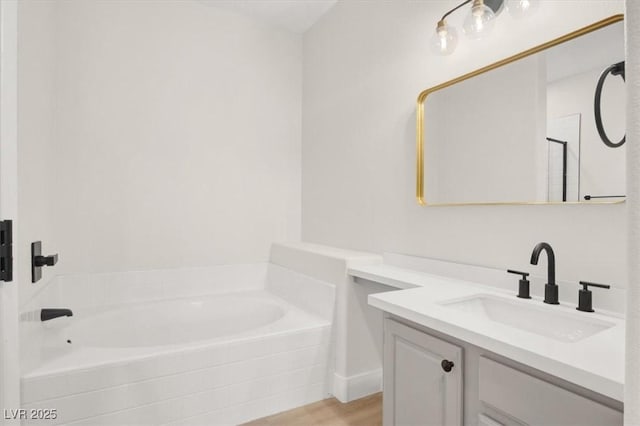 5655 E Sahara Ave Unit 2009, Las Vegas, NV 89142 - full bathroom featuring a garden tub, vanity, wood finished floors, and an enclosed shower