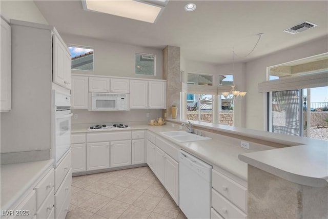 11032 Mission Lakes Ave, Las Vegas, NV 89134 - kitchen with white appliances, a sink, light tile patterned floors, light countertops, and white cabinetry