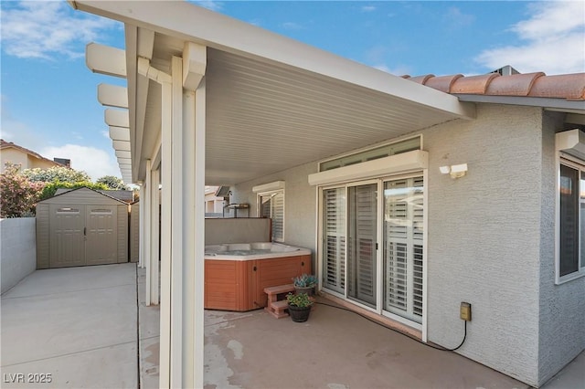 5553 Super Bowl Dr, Las Vegas, NV 89110 - view of patio featuring a hot tub, a storage shed, and an outbuilding