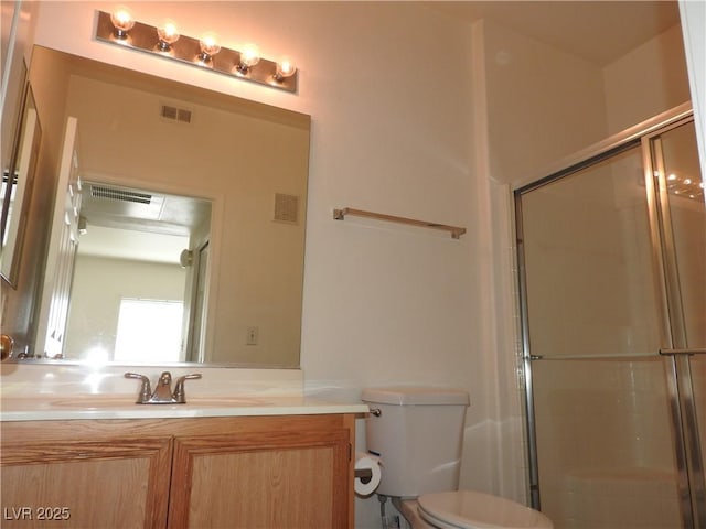 9470 Peace Way Unit 112, Las Vegas, NV 89147 - bathroom featuring a stall shower, toilet, and vanity