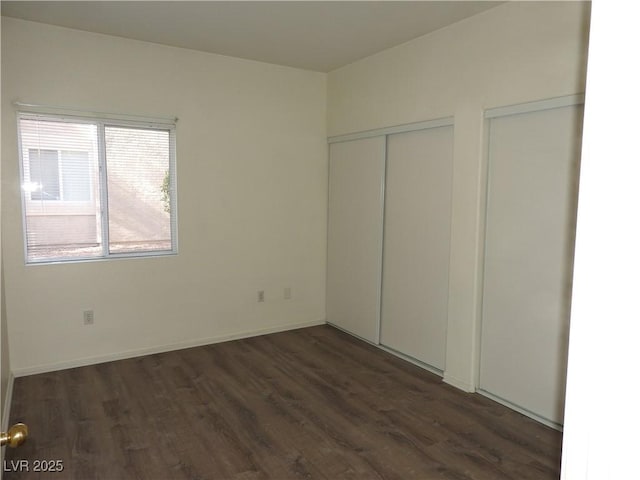 9470 Peace Way Unit 112, Las Vegas, NV 89147 - unfurnished bedroom featuring dark wood-style floors and baseboards