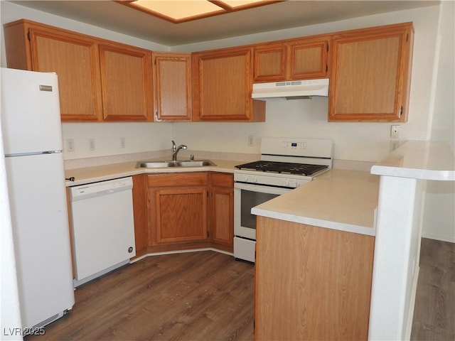 9470 Peace Way Unit 112, Las Vegas, NV 89147 - kitchen with white appliances, a sink, under cabinet range hood, dark wood finished floors, and light countertops