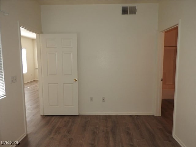 9470 Peace Way Unit 112, Las Vegas, NV 89147 - spare room with dark wood-style flooring and baseboards
