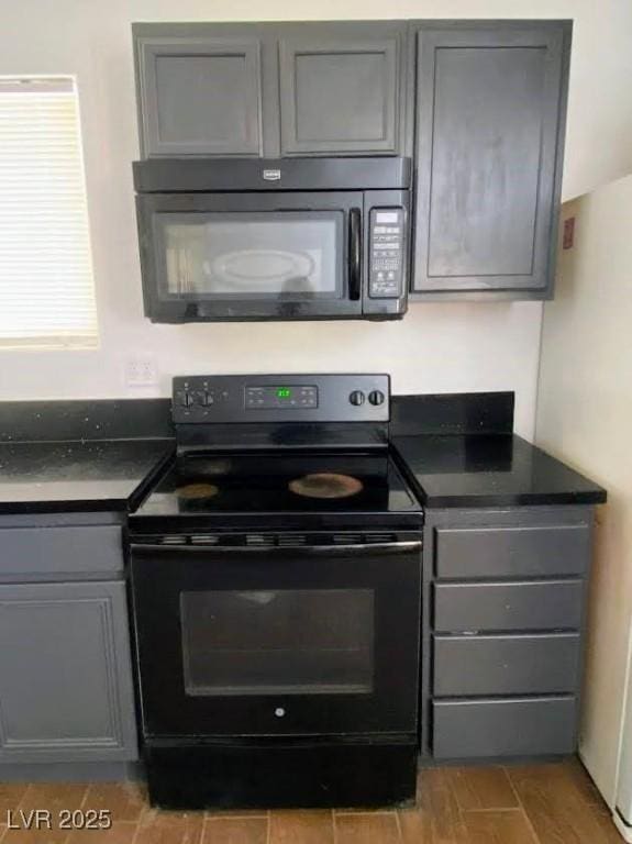 4910 Elizabeth St, Pahrump, NV 89048 - kitchen featuring black appliances, gray cabinets, and dark countertops