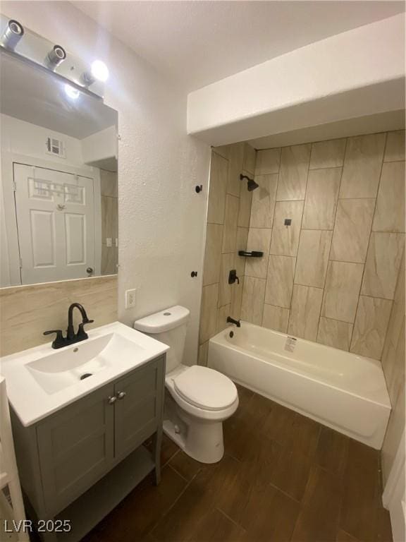4910 Elizabeth St, Pahrump, NV 89048 - full bath with wood finished floors, toilet, vanity, and washtub / shower combination