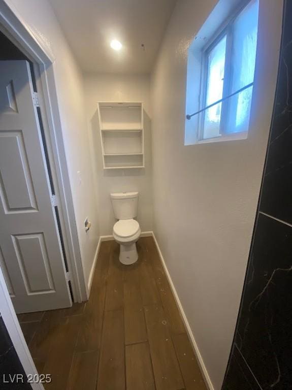 4910 Elizabeth St, Pahrump, NV 89048 - bathroom featuring baseboards, wood-type flooring, and toilet