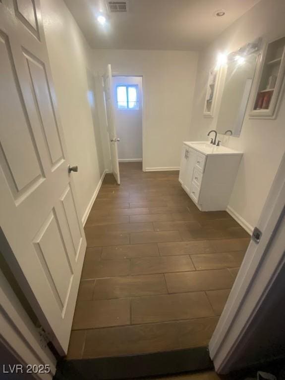 4910 Elizabeth St, Pahrump, NV 89048 - bathroom featuring wood finished floors, baseboards, and vanity