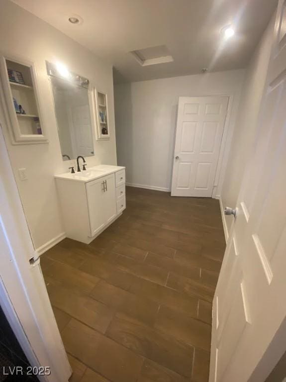 4910 Elizabeth St, Pahrump, NV 89048 - bathroom featuring wood finished floors, vanity, and baseboards