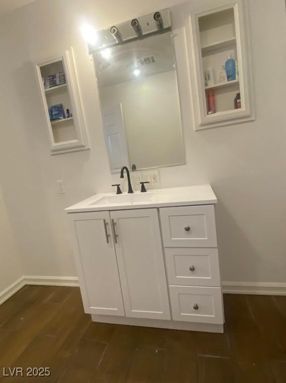 4910 Elizabeth St, Pahrump, NV 89048 - bathroom with wood finished floors, vanity, and baseboards