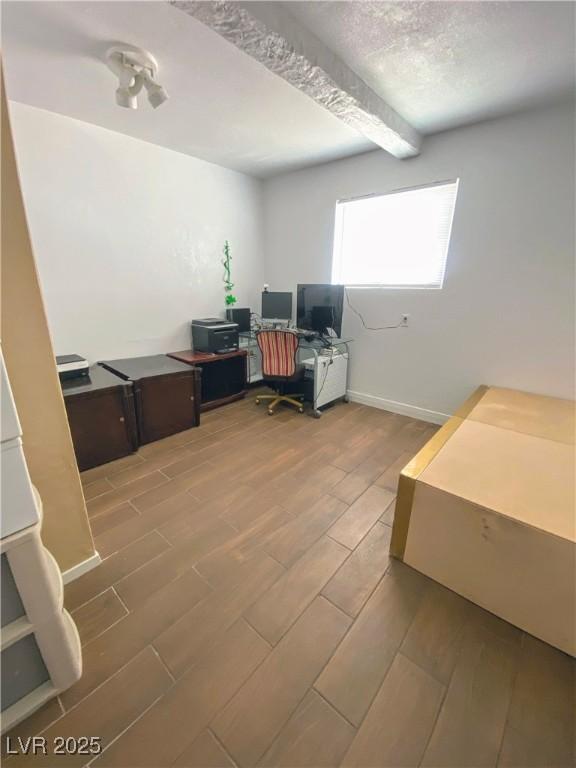4910 Elizabeth St, Pahrump, NV 89048 - office featuring wood finished floors and beamed ceiling