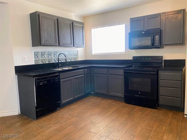 4910 Elizabeth St, Pahrump, NV 89048 - kitchen with black appliances, a sink, dark countertops, and light wood-type flooring