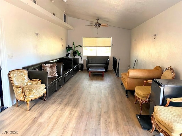 4910 Elizabeth St, Pahrump, NV 89048 - living room featuring vaulted ceiling, a ceiling fan, and light wood-style flooring