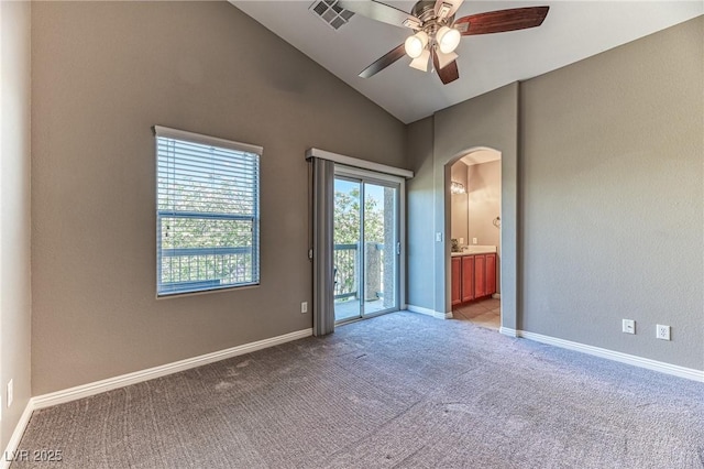unfurnished room with arched walkways, carpet floors, ceiling fan, lofted ceiling, and baseboards