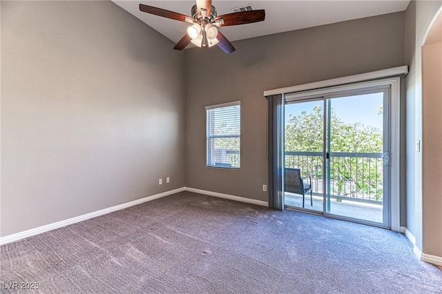 carpeted empty room with baseboards, lofted ceiling, and ceiling fan