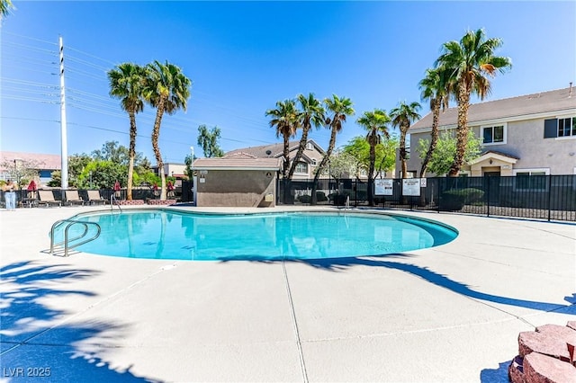 community pool featuring fence and a patio area