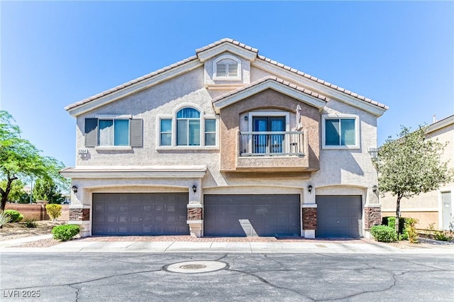 view of front of house featuring a garage, stucco siding, stone siding, and driveway