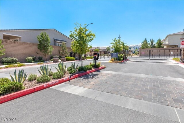 8929 Cassia Winds St, Las Vegas, NV 89166 - view of road with a gate, a gated entry, curbs, and a residential view