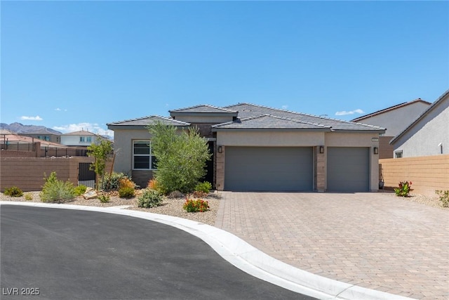 8929 Cassia Winds St, Las Vegas, NV 89166 - prairie-style house with stucco siding, fence, decorative driveway, and an attached garage