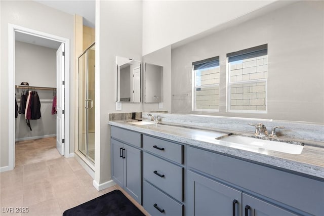 8929 Cassia Winds St, Las Vegas, NV 89166 - full bath featuring a shower stall, a walk in closet, double vanity, and tile patterned floors