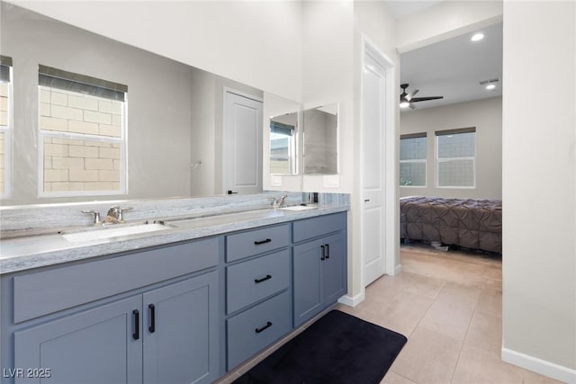 8929 Cassia Winds St, Las Vegas, NV 89166 - bathroom with tile patterned flooring, a ceiling fan, baseboards, double vanity, and ensuite bathroom
