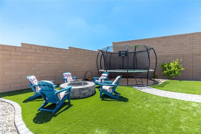 8929 Cassia Winds St, Las Vegas, NV 89166 - view of yard featuring a trampoline and a fire pit