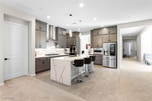 8929 Cassia Winds St, Las Vegas, NV 89166 - kitchen featuring gray cabinets, appliances with stainless steel finishes, wall chimney range hood, a breakfast bar area, and recessed lighting