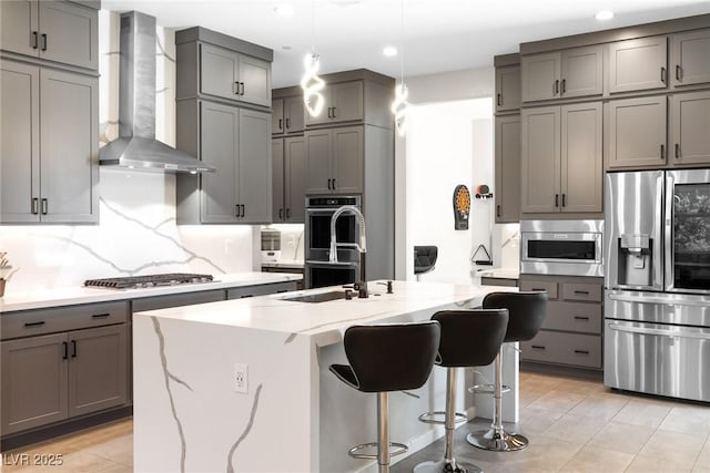8929 Cassia Winds St, Las Vegas, NV 89166 - kitchen featuring stainless steel appliances, wall chimney exhaust hood, gray cabinets, recessed lighting, and backsplash