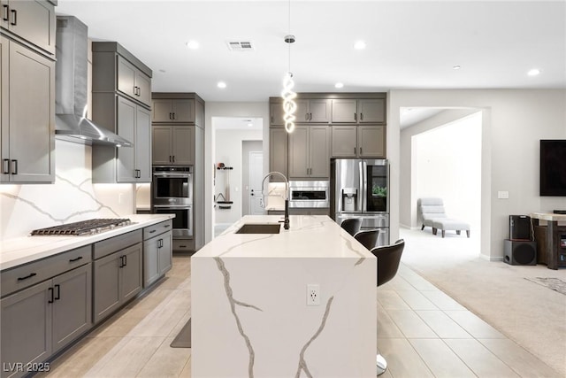 8929 Cassia Winds St, Las Vegas, NV 89166 - kitchen with a sink, gray cabinetry, appliances with stainless steel finishes, light colored carpet, and recessed lighting