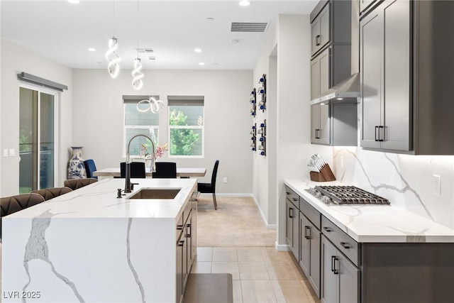 8929 Cassia Winds St, Las Vegas, NV 89166 - kitchen with a sink, gray cabinets, light colored carpet, stainless steel gas stovetop, and recessed lighting