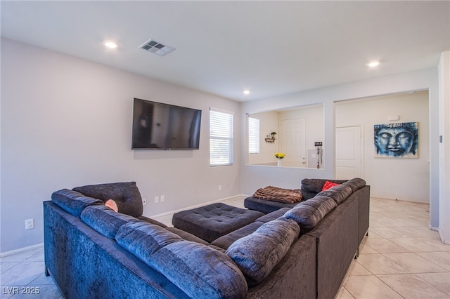 living room featuring light tile patterned flooring, recessed lighting, and baseboards
