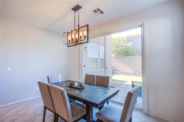 dining space featuring a chandelier, baseboards, and light tile patterned floors