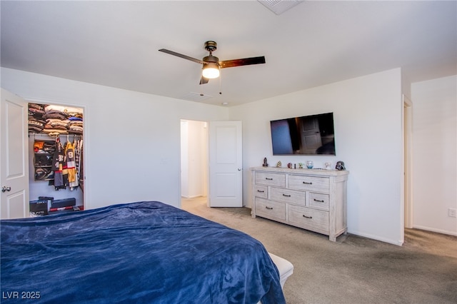 bedroom featuring light carpet and a ceiling fan