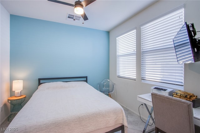 bedroom with multiple windows, baseboards, ceiling fan, and a desk