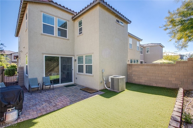back of property with stucco siding, central air condition unit, fence, and a patio