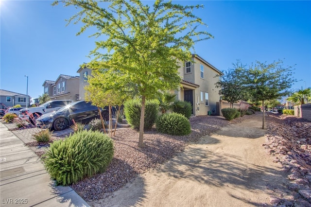 view of front of house featuring stucco siding and a residential view