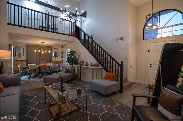 9013 Cypress Point Way, Las Vegas, NV 89117 - living area featuring a chandelier, a towering ceiling, wood finished floors, stairs, and baseboards