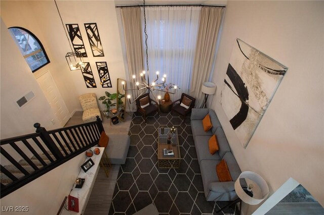 9013 Cypress Point Way, Las Vegas, NV 89117 - living area featuring a chandelier, stairway, and dark tile patterned floors