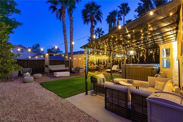 9013 Cypress Point Way, Las Vegas, NV 89117 - patio at night featuring a hot tub, an outdoor hangout area, and a patio area