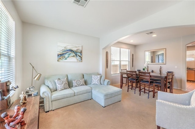 1213 High Altitude Ave, North Las Vegas, NV 89032 - living area with arched walkways, light colored carpet, baseboards, and recessed lighting