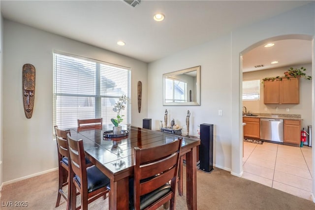 1213 High Altitude Ave, North Las Vegas, NV 89032 - dining space featuring light colored carpet, arched walkways, plenty of natural light, and recessed lighting